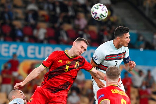 Portugal's Cristiano Ronaldo, right, and Belgium's Thomas Vermaelen compete to head the ball during the Euro 2020 soccer championship round of 16 match between Belgium and Portugal at La Cartuja stadium, Seville, Spain, Sunday, June 27, 2021. (Lluis Gene/Pool Photo via AP) Portugal's Cristiano Ronaldo, right, and Belgium's Thomas Vermaelen compete to head the ball during the Euro 2020 soccer championship round of 16 match between Belgium and Portugal at La Cartuja stadium, Seville, Spain, Sunday, June 27, 2021. (Lluis Gene/Pool Photo via AP)