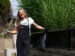 Flora Blathwayt, founder of Washed Up Cards, poses for a portrait on the banks of the river Thames, in Deptford, London, after collecting plastics to be turned into card designs in London, Britain, June 24, 2021. Picture taken June 24, 2021. REUTERS/Tom Nicholson