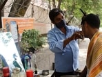 In east Delhi’s Mayur Vihar, Munna Thakur, another roadside barber, also attracts many customers from DDA’s SFS flats located right behind his shop.