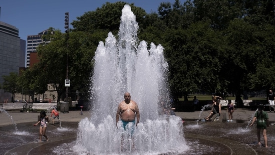 Pablo Miranda cools off in the Salmon Springs Fountain on June 27 in Portland, Oregon. The village of Lytton in British Columbia broke the record for Canada's all-time high, with a temperature of 46.6 degrees Celsius, said Environment Canada. And in Eugene, Oregon, a temperature of 43.3 degrees Celsius forced organisers to postpone the final day of the US Olympic track and field trials, moving afternoon events to the evening.(Nathan Howard / Getty Images / AFP)