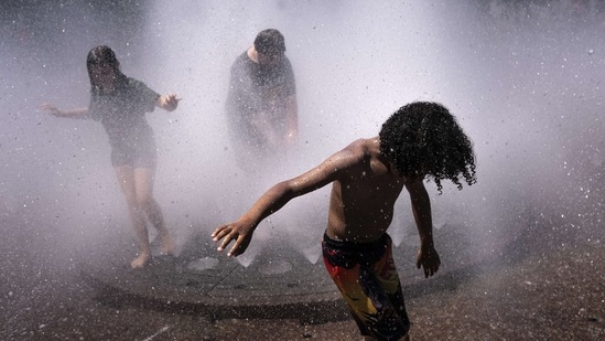 Kids playing in the Salmon Springs Fountain in Portland, Oregon on June 27 when the city hit 44.4 degrees Celsius, according to the US National Weather Service (NWS), breaking the city's record set a day earlier.(Nathan Howard / Getty Images / AFP)