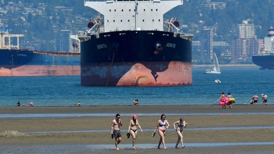 People head to the beach to cool off during the scorching weather of a heatwave in Vancouver, British Columbia, Canada on June 27. The warmth is building under a so-called heat dome that may have been exacerbated by climate change. It’s similar to the weather pattern earlier this month that led to a California heat wave, according to Jeff Masters, a meteorologist with Yale Climate Connections.(Jennifer Gauthier / REUTERS)