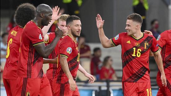 Belgium’s Thorgan Hazard (R) celebrates with teammates after scoring his team's first goal during the Euro 2020 Round of 16 match against Portugal at La Cartuja stadium in Seville on Sunday. (AP)