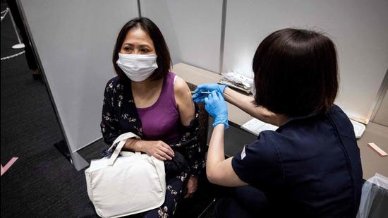 An employee of Japan’s Mori Building Company, a property management firm, receives the Moderna coronavirus vaccine in Tokyo. (AFP) An employee of Japan’s Mori Building Company, a property management firm, receives the Moderna coronavirus vaccine in Tokyo. (AFP)