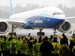 Boeing employees and others celebrate as a Boeing 777X airplane returns to a hangar after its first test flight at the company's facility in Seattle, Washington, in the US on January 25, 2020. 