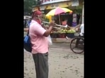 The image shows the man playing a song by RD Burman on the trumpet. The image shows the man playing a song by RD Burman on the trumpet.