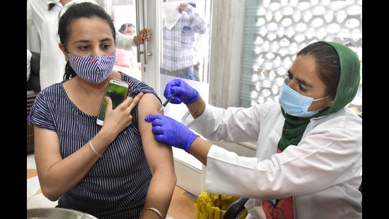 A health worker administers vaccine dose to a beneficiary during a camp at the Golden Temple in Amritsar. A health worker administers vaccine dose to a beneficiary during a camp at the Golden Temple in Amritsar.
