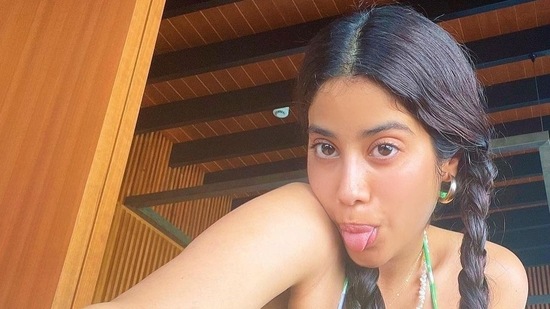 In another post, Janhvi wore a floral pink and green coloured bikini with a sarong, sporting hoops and two plaits. (Instagram)