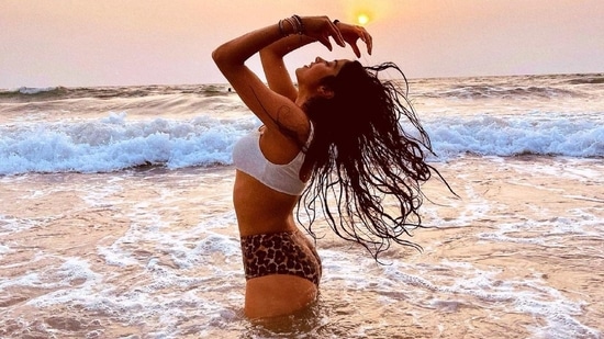 During a visit to the beach Janhvi can be seen wearing a high waisted leopard print bikini bottom with a white bikini top as she emerges out of the gushing sea water(Instagram)