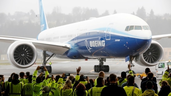 Boeing employees and others celebrate as a Boeing 777X airplane returns to a hangar after its first test flight at the company's facility in Seattle, Washington, in the US on January 25, 2020. (REUTERS/Terray Sylvester/File Photo)
