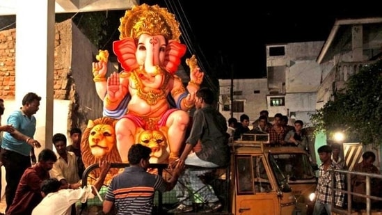 People load a giant idol of Lord Ganesha onto a truck. (AP) People load a giant idol of Lord Ganesha onto a truck. (AP)