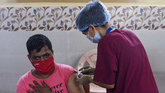 A resident gets inoculated against Covid-19 with a dose of the Covishield, in Mumbai on Tuesday.(AFP Photo)