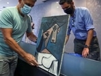 The paintings "Woman's Head" by Pablo Picasso and "Mill" by Piet Mondrian (not pictured), both stolen from Greece's National Gallery in 2012, are displayed during a presentation to members of the media at the Ministry of Citizen Protection in Athens, Greece on June 29. 