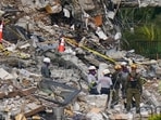 Local search and rescue personnel and members of an Israeli team work atop the rubble at the Champlain Towers South condo building.(AP) Local search and rescue personnel and members of an Israeli team work atop the rubble at the Champlain Towers South condo building.(AP)