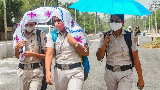 Security personnel covering themselves with a piece of cloth and holding an umbrella walk during the scorching heat, in New Delhi in June 30. IMD recordings showed that the maximum temperature at the Safdarjung observatory was 43 degrees Celsius on June 29, six degrees above what is considered normal for this time of the year. The minimum temperature was 27.4 degrees Celsius, a notch below normal. (Shahbaz Khan / PTI) Security personnel covering themselves with a piece of cloth and holding an umbrella walk during the scorching heat, in New Delhi in June 30. IMD recordings showed that the maximum temperature at the Safdarjung observatory was 43 degrees Celsius on June 29, six degrees above what is considered normal for this time of the year. The minimum temperature was 27.4 degrees Celsius, a notch below normal. (Shahbaz Khan / PTI)