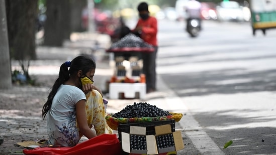 A girl selling fresh jamun (black plum) waits for customers at a roadside stall in New Delhi on June 30. An IMD official said this was the first heatwave recording of the season. “In the beginning and even till mid-June we have seen maximum temperatures in Delhi rise up to 48 degrees Celsius, but by end of June, temperatures tend to come down,” a senior IMD official told HT. (Sajjad Hussain / AFP) A girl selling fresh jamun (black plum) waits for customers at a roadside stall in New Delhi on June 30. An IMD official said this was the first heatwave recording of the season. “In the beginning and even till mid-June we have seen maximum temperatures in Delhi rise up to 48 degrees Celsius, but by end of June, temperatures tend to come down,” a senior IMD official told HT. (Sajjad Hussain / AFP)