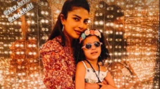 The 'Baywatch' actor poses with Krishna Sky in front of lit glass walls. (Instagram/@priyankachopra)