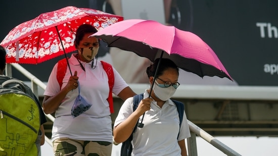 Security personnel carrying umbrellas to protect themselves from heat on a hot afternoon in New Delhi on June 29. Even though IMD has refrained from announcing a fresh monsoon arrival date, Skymet’s Palawat on June 29 said that looking at the current weather conditions, monsoon arrival in Delhi was unlikely before July 8, HT reported. (ANI) Security personnel carrying umbrellas to protect themselves from heat on a hot afternoon in New Delhi on June 29. Even though IMD has refrained from announcing a fresh monsoon arrival date, Skymet’s Palawat on June 29 said that looking at the current weather conditions, monsoon arrival in Delhi was unlikely before July 8, HT reported. (ANI)