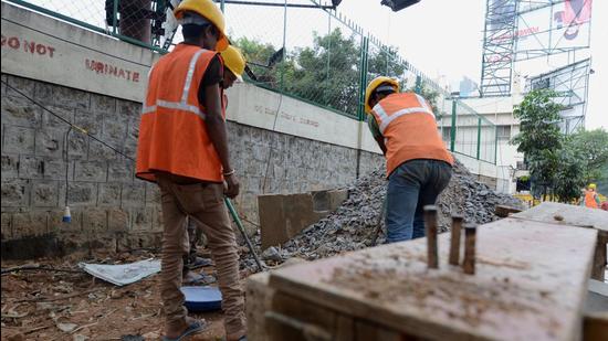 May 14, 2015 - Bengaluru, India: Workers repairing the footpath in Bengaluru. Photographed by Hemant Mishra/Mint May 14, 2015 - Bengaluru, India: Workers repairing the footpath in Bengaluru. Photographed by Hemant Mishra/Mint