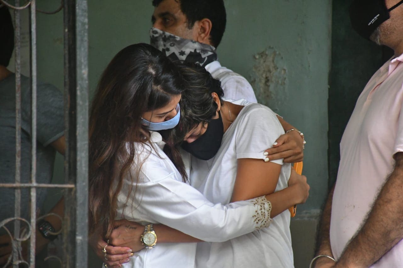 Mandira Bedi gets consoled by a friend. Mandira Bedi gets consoled by a friend.