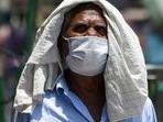 A man covers his head with a cloth to protect himself from heat on a hot afternoon in New Delhi. A man covers his head with a cloth to protect himself from heat on a hot afternoon in New Delhi.