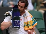 Britain's Andy Murray uses a towel during a break in play after going 5-6 down in the third set against Georgia's Nikoloz Basilashvili during their men's singles first round match on the first day of the 2021 Wimbledon Championships at The All England Tennis Club in Wimbledon, southwest London, on June 28, 2021.(AFP)