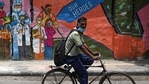 A cyclist passes by a wall mural depicting frontline Covid-19 coronavirus workers, in New Delhi.(Money Sharma / AFP) A cyclist passes by a wall mural depicting frontline Covid-19 coronavirus workers, in New Delhi.(Money Sharma / AFP)