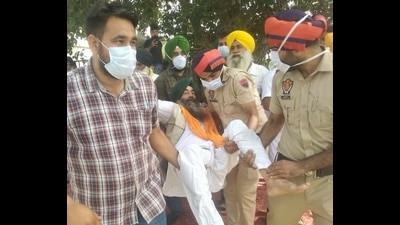 Police removing a protester from the protest site at Bargari in Faridkot district on Thursday. Police removing a protester from the protest site at Bargari in Faridkot district on Thursday.