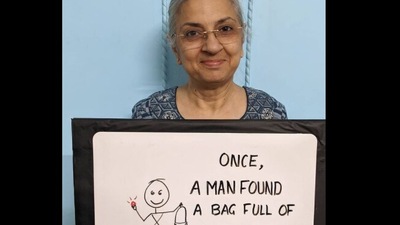 The image shows Poonam Sapra holding the a board. (Instagram/@motherwithsign)