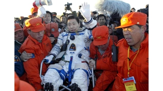 Crew carrying the first Chinese astronaut Yang Liwei after his landing on the Inner Mongolian grasslands of northern China on October 16, 2003. Beijing's mission control declared the country's landmark debut flight "a success."(Xinhua via AP)