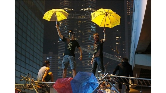 Protestors stand on a barricade at the occupied area outside government headquarters in Hong Kong on December 10, 2014. Relations between Hong Kong and mainland China came to a boil on several occasions, most recently with the passing of the national security law in 2020.(Kin Cheung / AP)