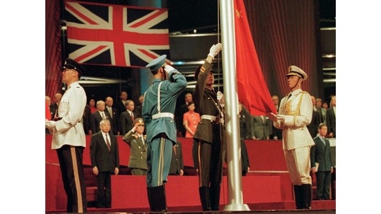 Members of the combined Chinese Armed Forces colour guard raise the Chinese flag at the Hong Kong convention centre marking the moment Hong Kong reverted to Chinese rule on June 30, 1997.(Kimimasa Mayama/Pool Photo via AP)