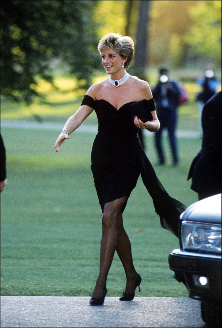 A black off-the-shoulder dress called the Revenge Dress by Christina Stambolian and a choker arriving at the Serpentine Gallery in London from 1994 A black off-the-shoulder dress called the Revenge Dress by Christina Stambolian and a choker arriving at the Serpentine Gallery in London from 1994