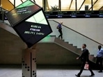 People walk through the lobby of the London Stock Exchange in London.