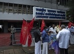 A security person checks on a visitor, left as activists of Centre of Indian Trade Unions (CITU) gather for a protest outside the Lakshadweep administration office in Kochi(AP) A security person checks on a visitor, left as activists of Centre of Indian Trade Unions (CITU) gather for a protest outside the Lakshadweep administration office in Kochi(AP)