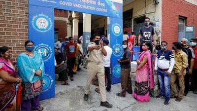 A police officer manages people who came to receive a dose of a Covid-19 vaccine outside a vaccination centre in Ahmedabad on June 30. Even as cases are on the decline, experts worry India could be at risk of another surge of the virus because less than 5% of the population has been fully vaccinated. (Amit Dave / REUTERS) A police officer manages people who came to receive a dose of a Covid-19 vaccine outside a vaccination centre in Ahmedabad on June 30. Even as cases are on the decline, experts worry India could be at risk of another surge of the virus because less than 5% of the population has been fully vaccinated. (Amit Dave / REUTERS)