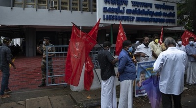 A security person checks on a visitor, left as activists of Centre of Indian Trade Unions (CITU) gather for a protest outside the Lakshadweep administration office in Kochi (AP) A security person checks on a visitor, left as activists of Centre of Indian Trade Unions (CITU) gather for a protest outside the Lakshadweep administration office in Kochi (AP)