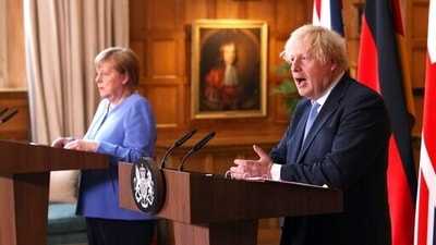Britain's Prime Minister Boris Johnson, right and German Chancellor Angela Merkel. (AP)