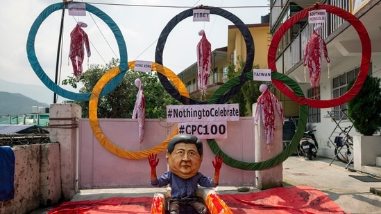 A recent study showed that developed economies in Europe, North America and Asia Pacific have developed highly unfavourable views regarding China. In this photo, An exile Tibetan activist wearing a mask in the likeness of Chinese president Xi Jinping sits in a tub filled with red fluid representing blood in Dharmsala.(AP )