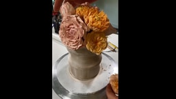 The image shows the cake, which looks like a bouquet of flowers, in process of being created.