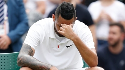 Wimbledon: Australia's Nick Kyrgios reacts after losing his match by a walkover as he sustained an injury and was forced to retire. (REUTERS)