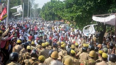 Samajwadi Party workers and police personnel in Prayagraj. (PTI)