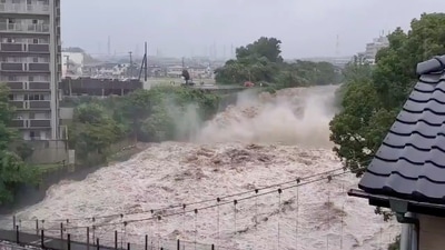 View of a swollen river from heavy rainfall in Shunto district, Shizuoka, Japan on July 3 in this still image obtained from social media video. The landslides appeared to have struck multiple times, about as fast as a car. Footage showed a powerful, black mudslide slither down a mountain, knocking over and crushing houses and sweeping away cars in its path. Helpless neighbors watched in horror, some recording on their phones. Footage from public broadcaster NHK TV showed a part of a bridge had collapsed. (Twitter @FUSAPOOH via REUTERS) View of a swollen river from heavy rainfall in Shunto district, Shizuoka, Japan on July 3 in this still image obtained from social media video. The landslides appeared to have struck multiple times, about as fast as a car. Footage showed a powerful, black mudslide slither down a mountain, knocking over and crushing houses and sweeping away cars in its path. Helpless neighbors watched in horror, some recording on their phones. Footage from public broadcaster NHK TV showed a part of a bridge had collapsed. (Twitter @FUSAPOOH via REUTERS)