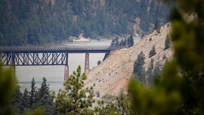 A rail bridge spans the Fraser River as a wildfire burns in Lytton, British Columbia, Friday, July 2, 2021. (Darryl Dyck/The Canadian Press via AP) A rail bridge spans the Fraser River as a wildfire burns in Lytton, British Columbia, Friday, July 2, 2021. (Darryl Dyck/The Canadian Press via AP)