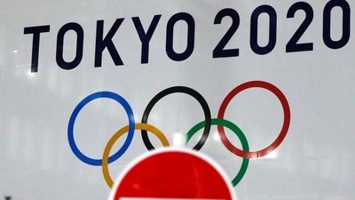 The logo of Tokyo 2020 Olympic Games, that have been postponed to 2021, is seen through a traffic sign at Tokyo Metropolitan Government Office building in Tokyo, Japan. (File photo)
