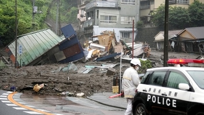 A police vehicle near houses damaged by a mudslide at Izusan district in Atami on July 3. Atami is a quaint seaside resort area in Shizuoka prefecture, about 100 kilometers southwest of Tokyo. The area that was hit by the mudslide, Izusan, includes hot springs, residential areas, shopping streets and a famous shrine. (Kyodo via REUTERS) A police vehicle near houses damaged by a mudslide at Izusan district in Atami on July 3. Atami is a quaint seaside resort area in Shizuoka prefecture, about 100 kilometers southwest of Tokyo. The area that was hit by the mudslide, Izusan, includes hot springs, residential areas, shopping streets and a famous shrine. (Kyodo via REUTERS)