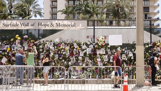 A general view of a memorial that has pictures of some of the missing from the partially collapsed 12-story Champlain Towers South condo building on July 02, 2021 in Surfside, Florida.(AFP)