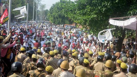 Samajwadi Party workers and police personnel in Prayagraj. (PTI)