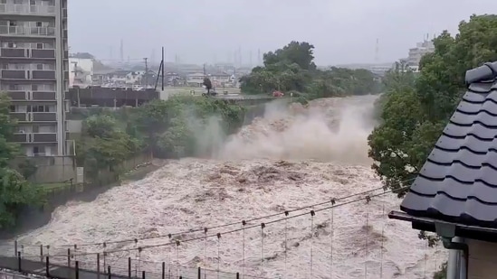 View of a swollen river from heavy rainfall in Shunto district, Shizuoka, Japan on July 3 in this still image obtained from social media video. The landslides appeared to have struck multiple times, about as fast as a car. Footage showed a powerful, black mudslide slither down a mountain, knocking over and crushing houses and sweeping away cars in its path. Helpless neighbors watched in horror, some recording on their phones. Footage from public broadcaster NHK TV showed a part of a bridge had collapsed.(Twitter @FUSAPOOH via REUTERS)
