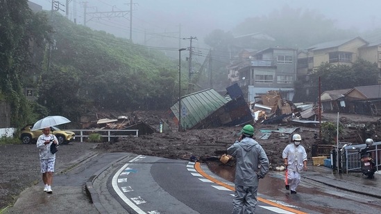 A road is covered by mud and debris following heavy rain in Atami city, Shizuoka prefecture on July 3. Both Kawakatsu and Sugiyama said it had been raining hard in the area all morning, AP reported. Self-defense forces will join firefighters and police in the rescue operation, and a minister from the national government had also arrived.(Satoru Watanabe via AP)